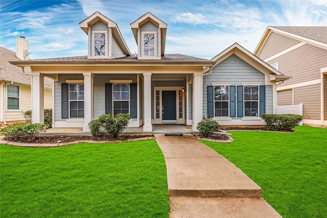 view of front of property featuring covered porch and a front lawn