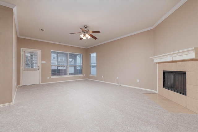 unfurnished living room with ornamental molding, light colored carpet, ceiling fan, and a fireplace