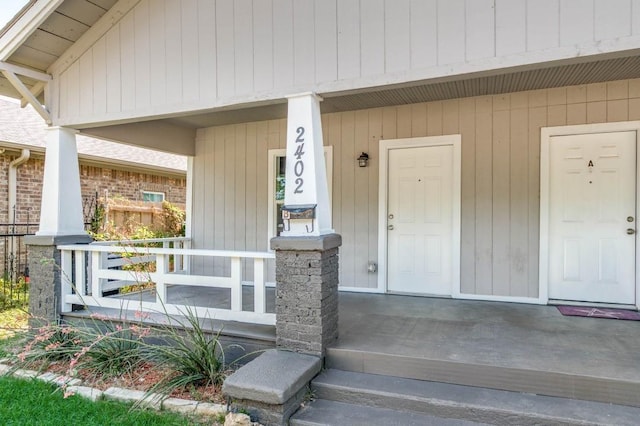 view of exterior entry with a porch