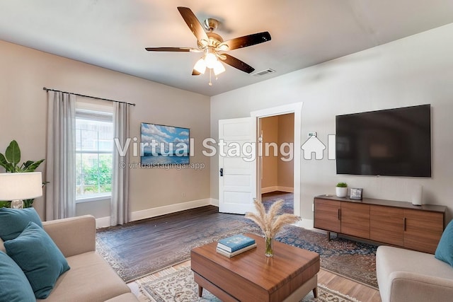 living room with ceiling fan and dark hardwood / wood-style flooring