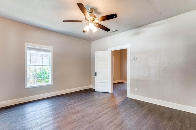 spare room with ceiling fan and dark hardwood / wood-style floors