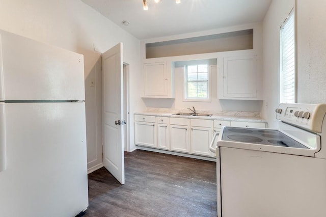 kitchen featuring sink, white appliances, dark wood-type flooring, and white cabinets