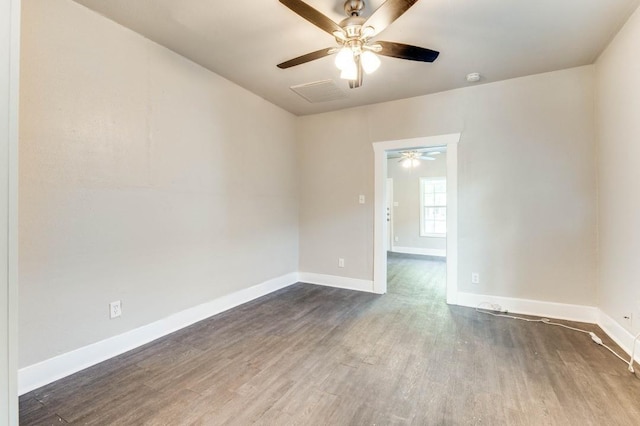 spare room with dark hardwood / wood-style flooring and ceiling fan