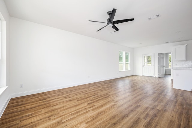 unfurnished living room featuring hardwood / wood-style floors and ceiling fan