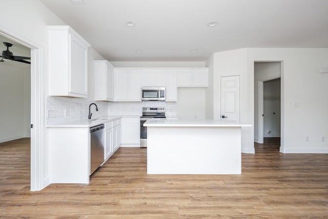 kitchen featuring sink, a center island, white cabinets, and appliances with stainless steel finishes