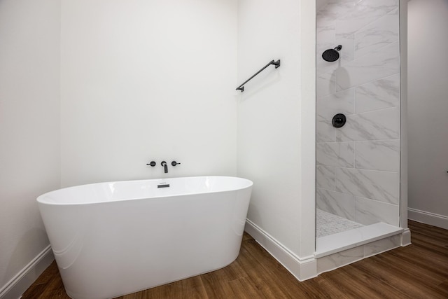 bathroom featuring hardwood / wood-style flooring and separate shower and tub