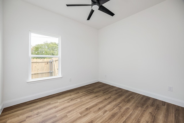 empty room with ceiling fan and wood-type flooring