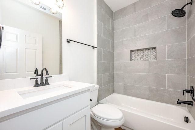 full bathroom featuring vanity, toilet, and tiled shower / bath