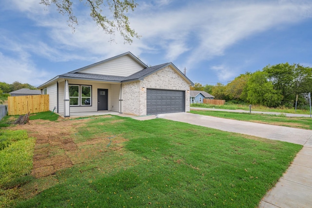 view of front of property with a garage and a front yard