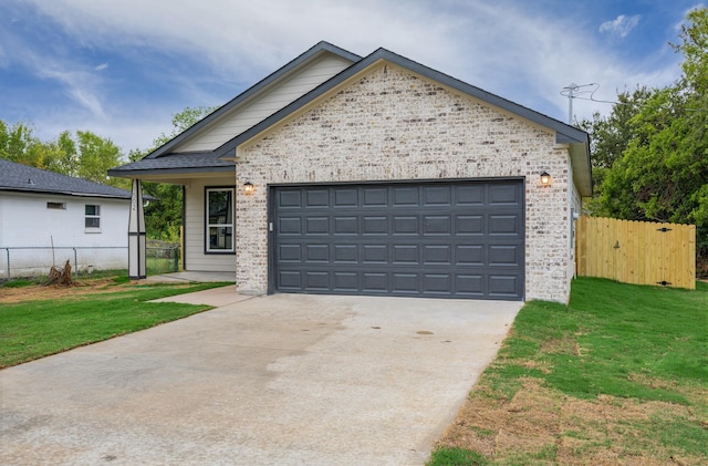 view of front of house with a garage and a front lawn