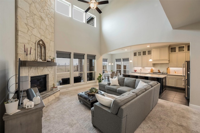 2402 Topaz Dr, Rockwall, TX 75087 - living room with light carpet, sink, a stone fireplace, and ceiling fan