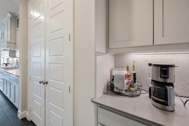 2402 Topaz Dr, Rockwall, TX 75087 - kitchen with tasteful backsplash, dark tile patterned flooring, and white cabinets