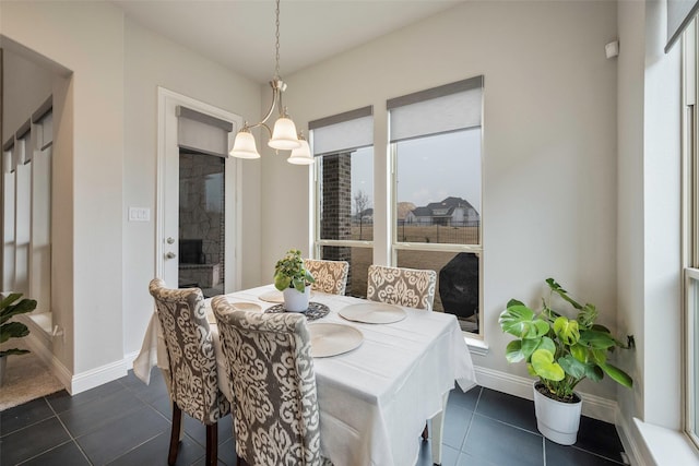 2402 Topaz Dr, Rockwall, TX 75087 - dining area featuring an inviting chandelier and dark tile patterned flooring