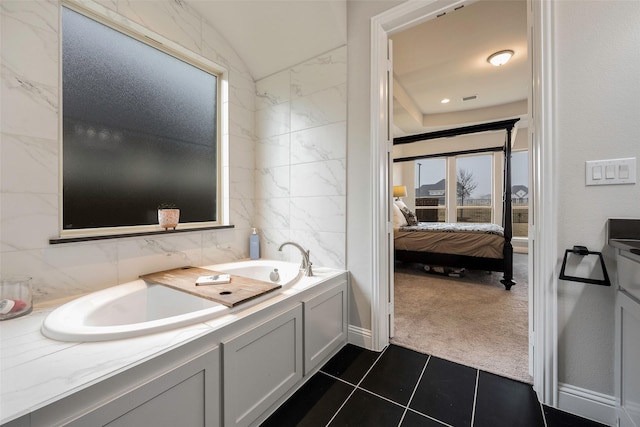 2402 Topaz Dr, Rockwall, TX 75087 - bathroom featuring tile patterned floors, vaulted ceiling, tile walls, a tub, and backsplash