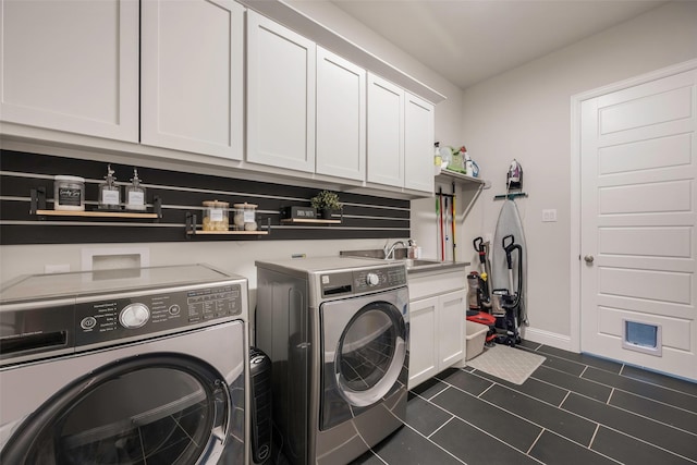 2402 Topaz Dr, Rockwall, TX 75087 - laundry area featuring cabinets, dark tile patterned floors, sink, and washing machine and clothes dryer