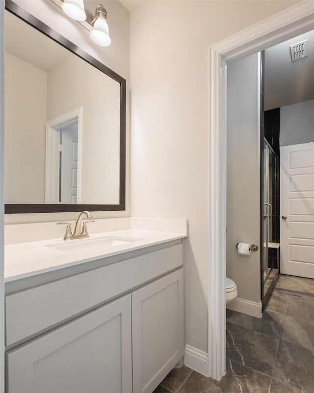 2402 Topaz Dr, Rockwall, TX 75087 - bathroom featuring toilet, vanity, and walk in shower