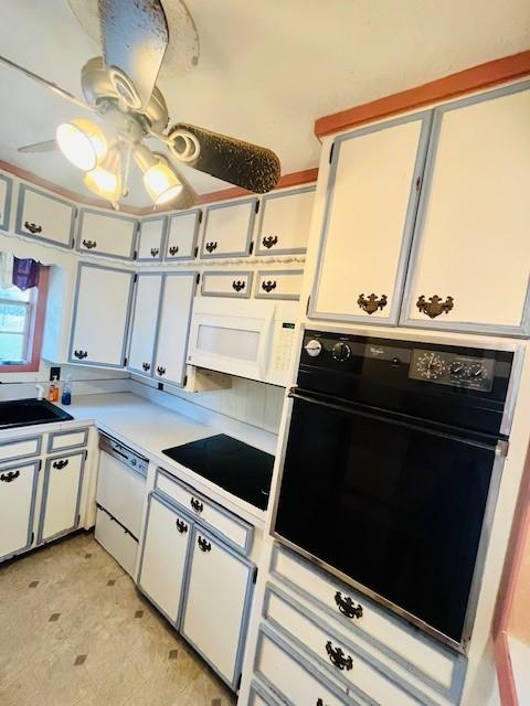 kitchen featuring white cabinetry, sink, white appliances, and ceiling fan