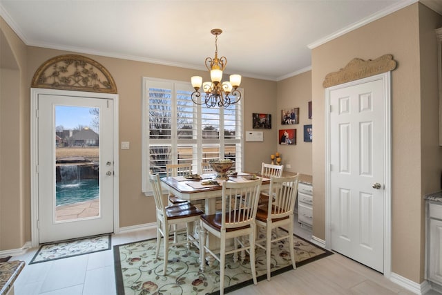 dining space featuring baseboards, an inviting chandelier, and ornamental molding