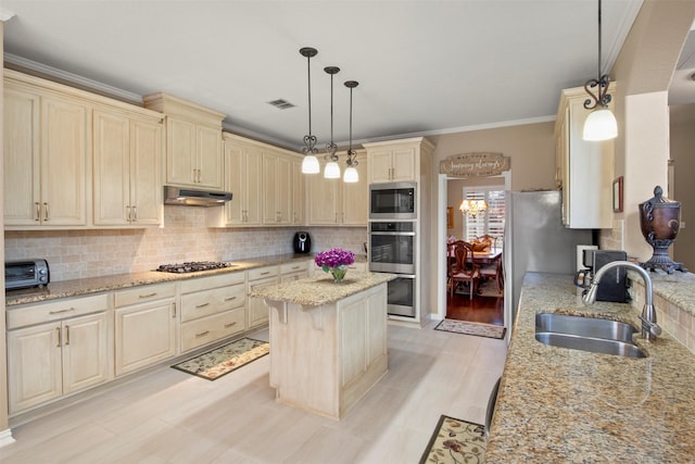 kitchen featuring visible vents, a sink, cream cabinetry, appliances with stainless steel finishes, and under cabinet range hood