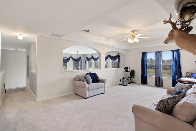 living room featuring carpet flooring, baseboards, and visible vents