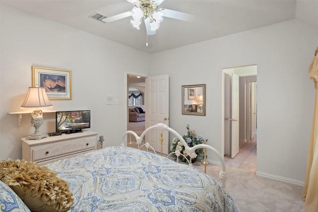 bedroom with visible vents, baseboards, light colored carpet, ceiling fan, and vaulted ceiling