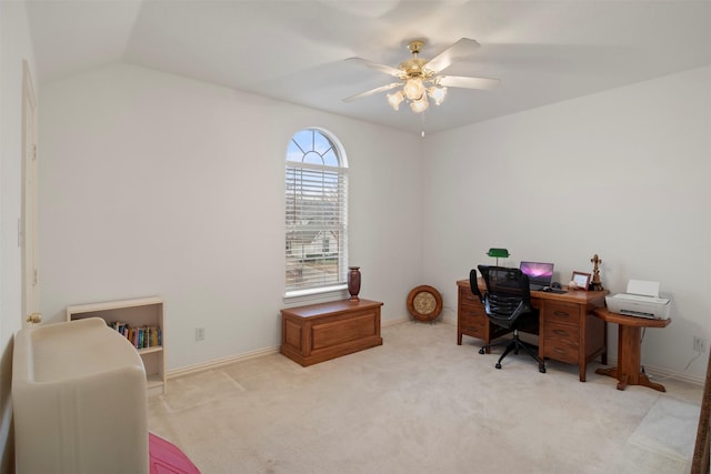 office space with baseboards, light colored carpet, ceiling fan, and vaulted ceiling