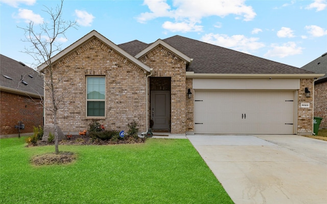 view of front of property featuring a garage and a front yard