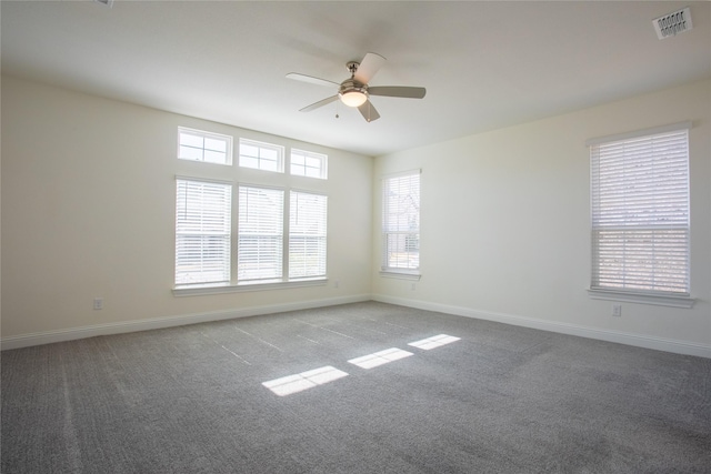 carpeted spare room with ceiling fan