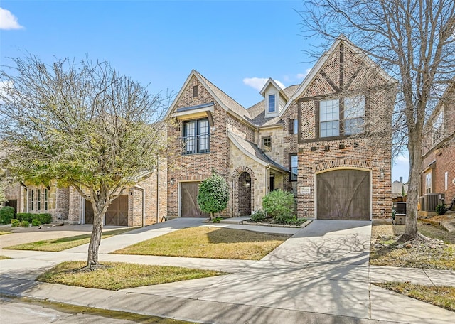 tudor home featuring a garage and central AC