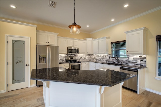 kitchen featuring dark stone countertops, sink, stainless steel appliances, and white cabinets