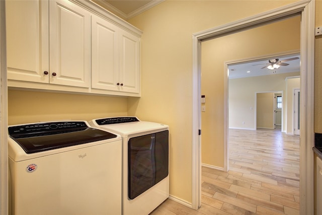 laundry area featuring washing machine and clothes dryer, crown molding, cabinets, light wood-type flooring, and ceiling fan