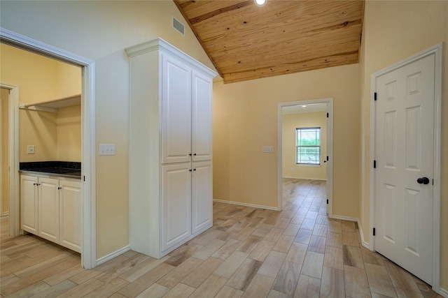 hallway with vaulted ceiling, wood ceiling, and light wood-type flooring