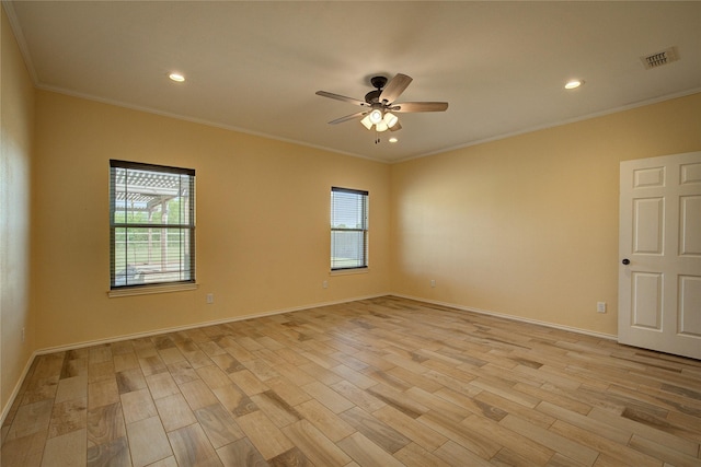 spare room with crown molding, ceiling fan, and light wood-type flooring