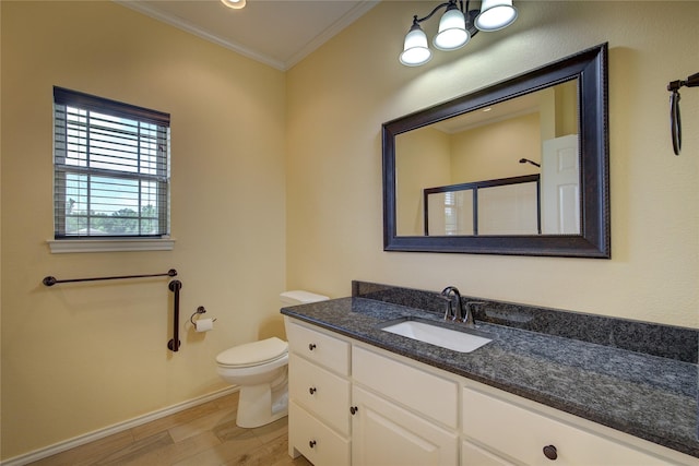 bathroom with hardwood / wood-style floors, vanity, an enclosed shower, ornamental molding, and toilet