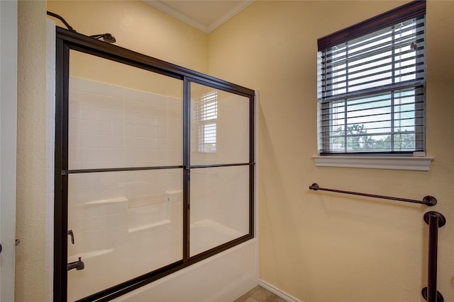 bathroom with ornamental molding and shower / bath combination with glass door