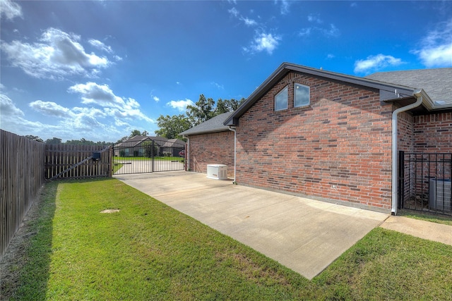 view of yard featuring a patio and central AC unit