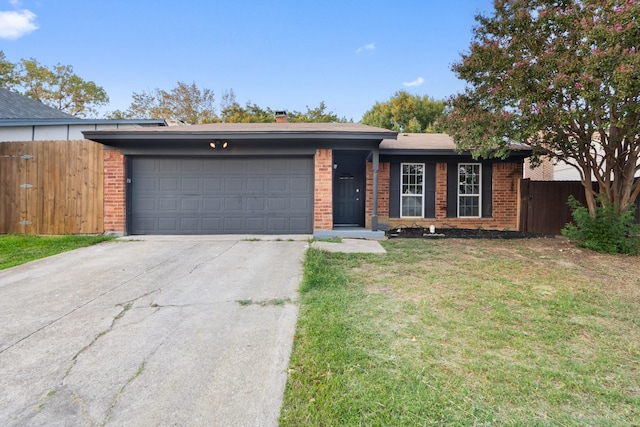 ranch-style home with a garage and a front lawn