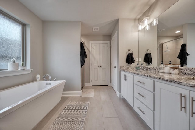 bathroom featuring vanity, tile patterned floors, and separate shower and tub