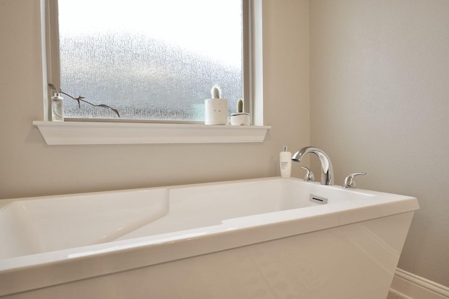 bathroom with a tub to relax in