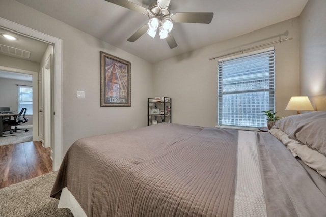 bedroom with hardwood / wood-style flooring and ceiling fan