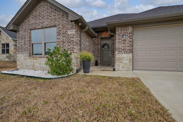 view of front of property with a garage and a front lawn