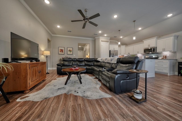 living room featuring crown molding, hardwood / wood-style floors, and ceiling fan