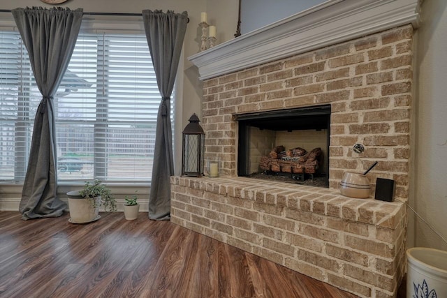 interior details with a brick fireplace and hardwood / wood-style floors