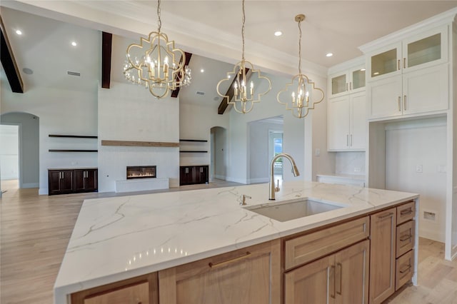 121 Ford Ct, Weston, TX 75009 - kitchen featuring a sink, open floor plan, a chandelier, arched walkways, and beam ceiling