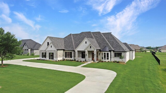 121 Ford Ct, Weston, TX 75009 - french country home with a front yard, roof with shingles, brick siding, and curved driveway
