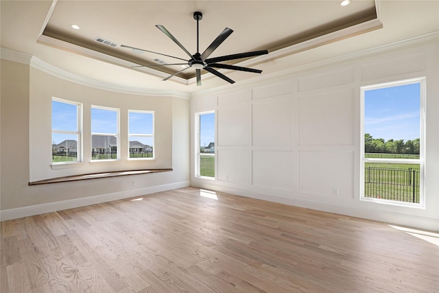 121 Ford Ct, Weston, TX 75009 - spare room featuring a raised ceiling, crown molding, a decorative wall, a ceiling fan, and light wood-style flooring