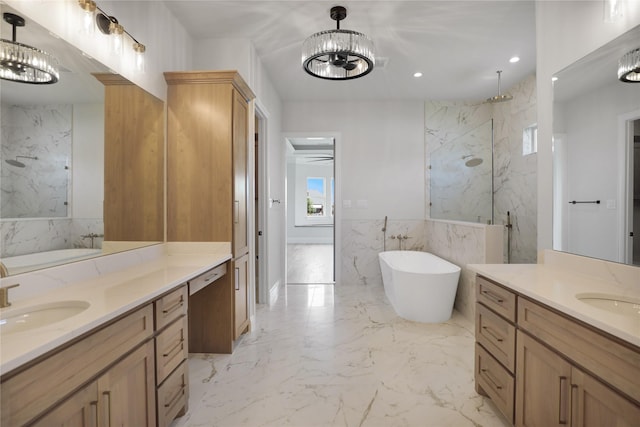 121 Ford Ct, Weston, TX 75009 - bathroom featuring a marble finish shower, a freestanding bath, two vanities, marble tiled flooring, and recessed lighting