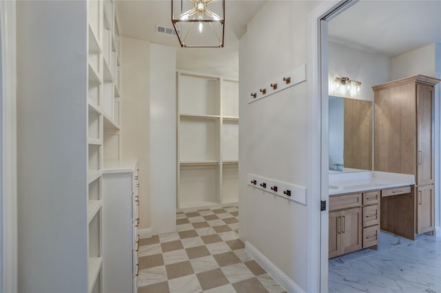 121 Ford Ct, Weston, TX 75009 - walk in closet featuring a chandelier