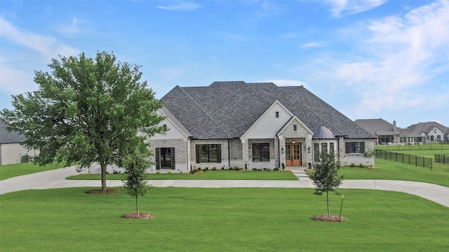 121 Ford Ct, Weston, TX 75009 - french country inspired facade with curved driveway, stone siding, and french doors