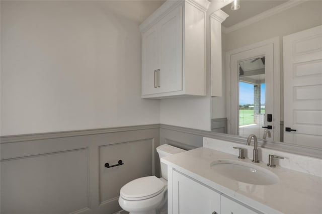 121 Ford Ct, Weston, TX 75009 - half bathroom with a decorative wall, vanity, toilet, crown molding, and wainscoting